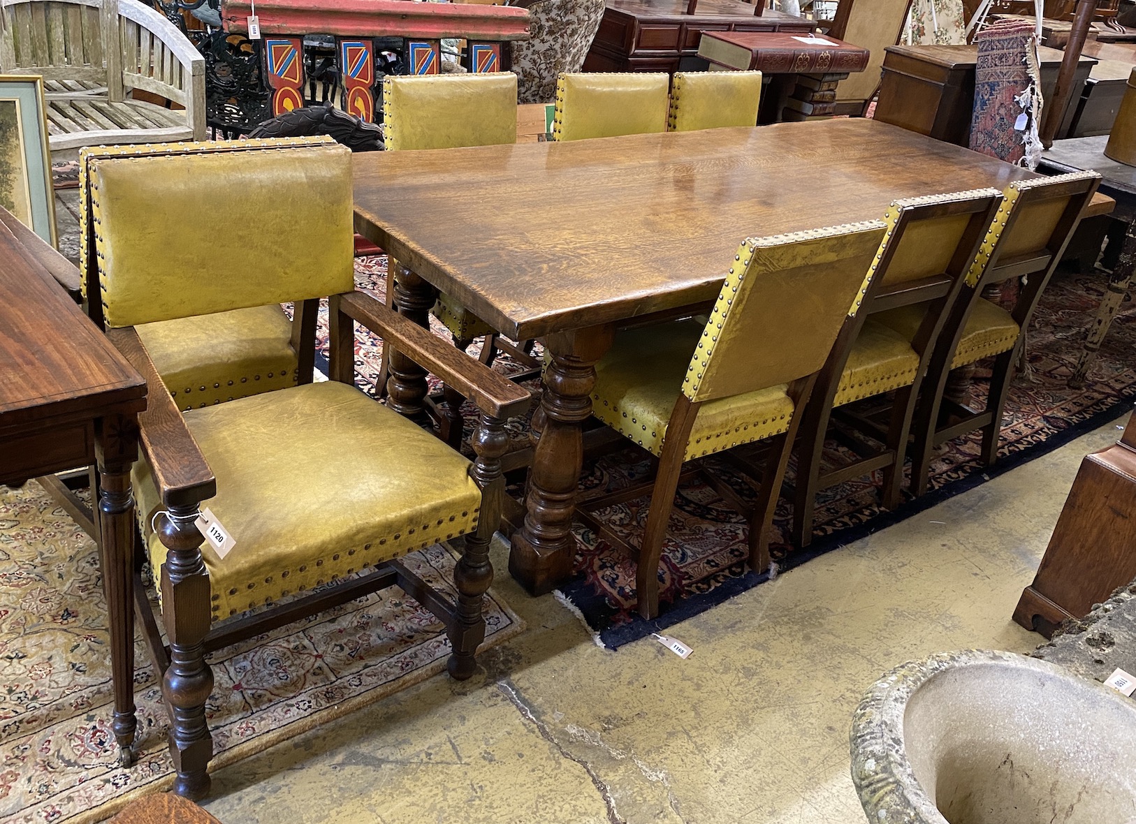 An 18th century style rectangular oak refectory dining table, length 224cm, width 92cm, height 77cm and eight dining chairs (2 with arms)